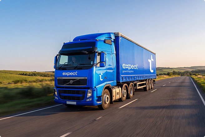 Blue Expect Logistics lorry travelling along a rural road through rolling countryside.